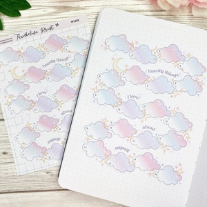 May include: A printable sheet of 20 cloud stickers with stars and a crescent moon. The clouds are in shades of pink, blue, and purple. The text "I love about myself" and "twenty things" is printed on the sheet.