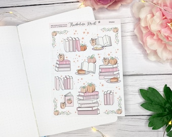 May include: A sticker sheet with fall-themed illustrations. The sheet features stacks of books, pumpkins, mugs, and pie slices in shades of pink, orange, and brown. The text "Thumbelina Print" is at the top.