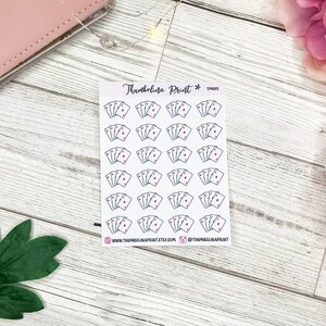 May include: A sheet of 25 stickers featuring a simple line drawing of four playing cards with a red heart on each card. The stickers are white with black outlines and are arranged in five rows of five stickers. The text "Thumbelina Print*" and "TP465" is printed in the top right corner of the sheet.