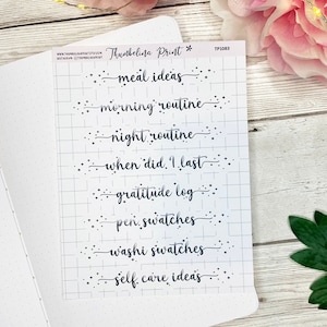 May include: A sheet of printable planner stickers with a grid background. The stickers feature a variety of phrases including "meal ideas", "morning routine", "night routine", "when did I last", "gratitude log", "pen swatches", "washi swatches", and "self care ideas".