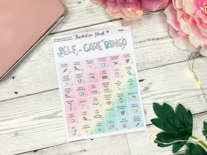 May include: A Self-Care Bingo card with a pastel rainbow gradient background. The card features a grid of self-care activities, each with a small illustration. Activities include journaling, taking a bath, and listening to music.