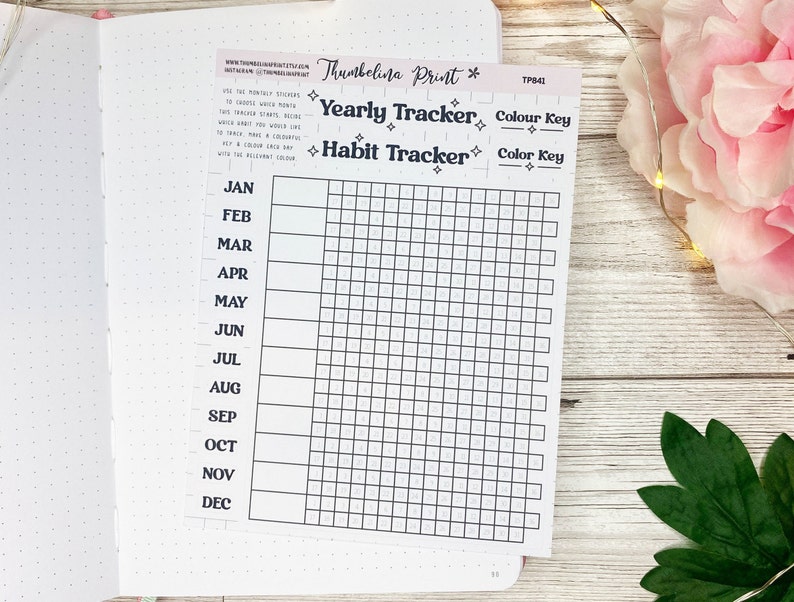 May include: A black and white printable habit tracker with a grid of squares for each day of the year. The months are listed on the left side of the grid. The text "Yearly Tracker" and "Habit Tracker" are printed at the top of the page. The text "Color Key" is printed twice on the right side of the page.