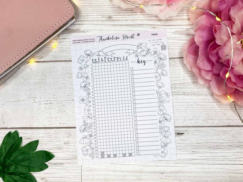 May include: A printable planner page with a floral border and a gridded section for tracking habits or goals. The page also includes a key section for labeling the grid squares. The text "Thumbelina Print" and "key" are visible on the page.