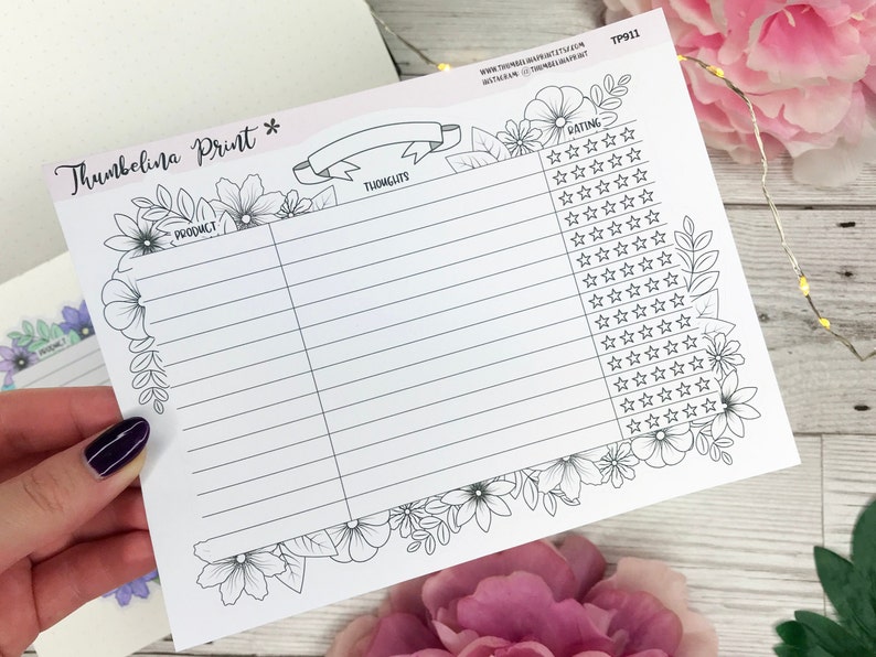 May include: A white paper planner insert featuring a black ink floral border. The page includes columns labeled Product, Thoughts, and Rating with rows of stars for tracking. Text includes Thumbelina Print, TP911, and social media handles.