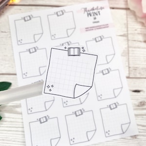 May include: A sheet of printable planner stickers with a gridded design. The stickers feature a book with a bookmark and a star design. The text "TheNotebookPrint" is visible in the top right corner of the image.