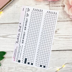 May include: A printable year in pixels tracker with a grid of 31 squares for each month. The tracker is designed to be used for tracking goals, habits, or other activities.