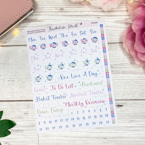 May include: A sheet of planner stickers with colorful text and designs. The stickers include days of the week, numbers, and labels such as "Goals," "To Do List," and "Monthly Overview." The background is white with a wooden texture.