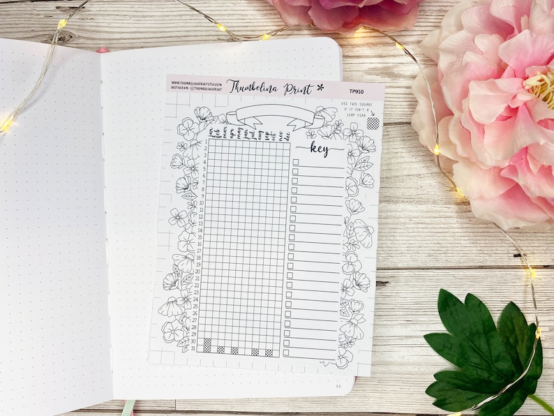 May include: A black and white printable planner page with a floral border. The page is divided into a grid with numbers 1-31 and a key with blank lines for writing. The text "Thumbelina Print" is at the top of the page.