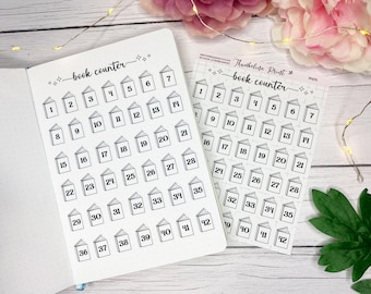 May include: Two white sheets with black book graphics and numbers for tracking reading progress. One sheet is in a notebook, the other is a sticker sheet. The text "book counter" is at the top of each sheet.