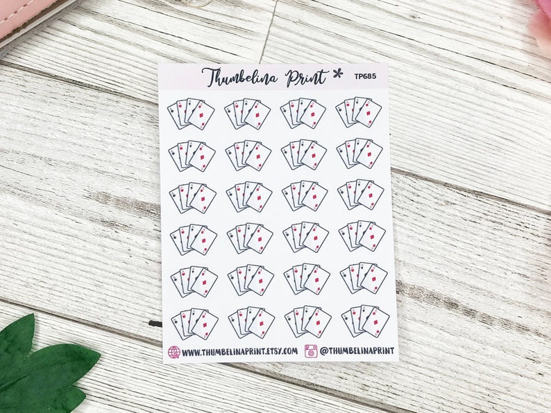 May include: A sheet of 18 stickers featuring a repeated design of four playing cards with a red diamond suit. The stickers are on a white background with the text "Thumbelina Print* TP685" at the top.