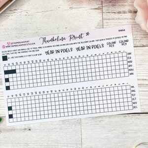 May include: A printable year in pixels tracker with a color key. The tracker is divided into two sections, one for each half of the year. Each section has a grid of 31 squares, representing the days of the month. The months are labeled on the right side of the tracker. The color key is labeled "Color Key" and "Colour Key".