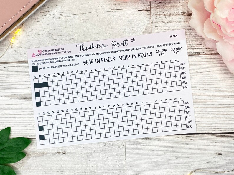 May include: A printable year in pixels tracker with a color key. The tracker is divided into two sections, one for each half of the year. Each section has a grid of 31 squares, representing the days of the month. The months are labeled on the right side of the tracker. The color key is labeled "Color Key" and "Colour Key".