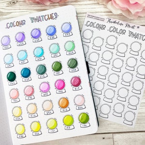 May include: A sheet of paper with a grid of 36 circles, each representing a color swatch. The circles are labeled with numbers. The paper is titled "COLOUR COLOR SWATCHES" and "Thumbelina Print*" with the number 192230.  The sheet is next to a page in a notebook with a grid of 36 circles, each filled with a different color. The circles are labeled with numbers. The page is titled "COLOUR SWATCHES".