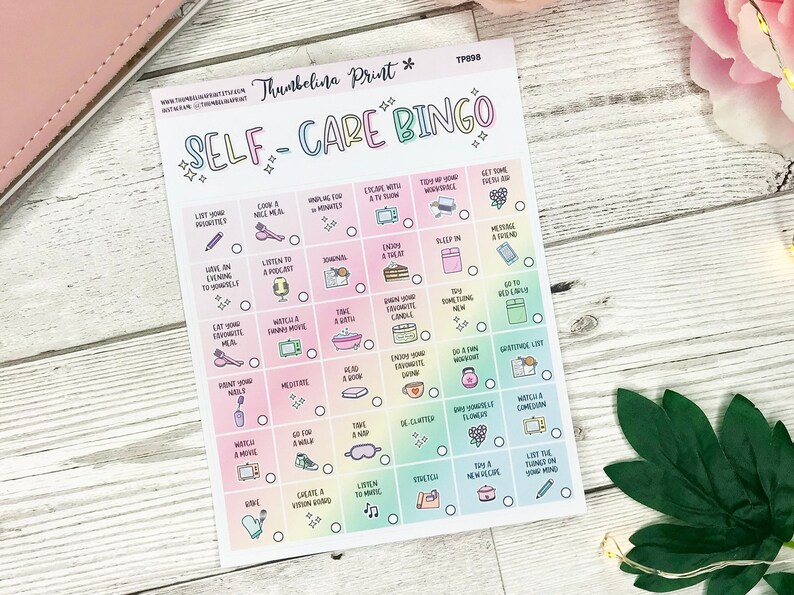 May include: A Self-Care Bingo card with a pastel rainbow gradient background. The card features a grid of boxes, each with a self-care activity such as "Cook a nice meal," "Listen to a podcast," and "Go to bed early." The card is designed to encourage self-care.