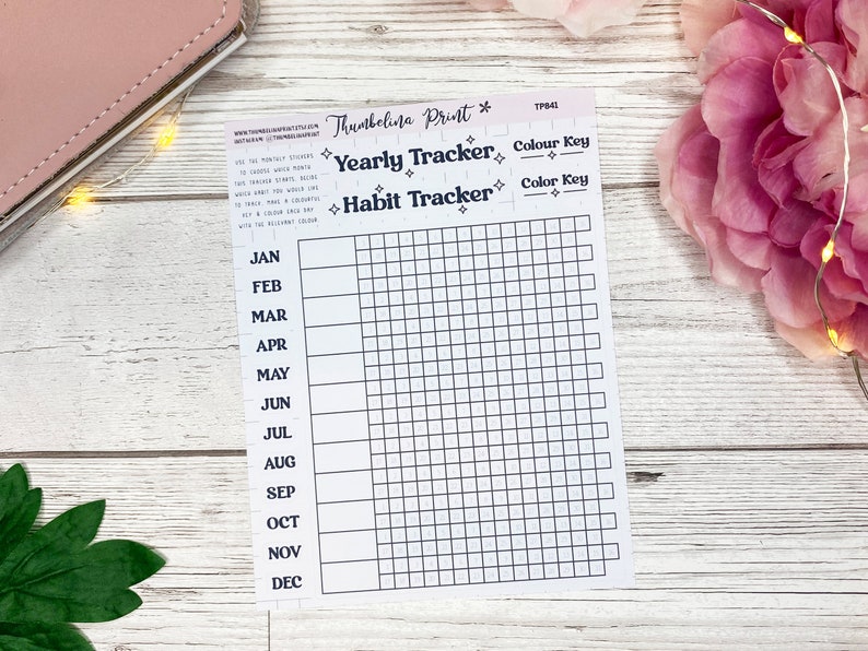 May include: A printable habit tracker with a grid for each month of the year. The tracker is labeled "Yearly Tracker" and "Habit Tracker" with a color key section.