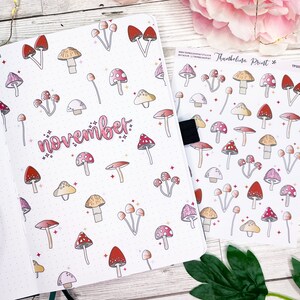 May include: A sheet of stickers featuring a variety of colourful mushrooms with white backgrounds. The stickers are arranged in rows and columns. The text "Thumbelina Print" is printed in the top right corner of the sheet.