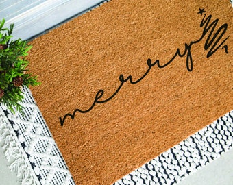 May include: A brown coir doormat with the text "merry" written in black cursive script with a star above the "y".