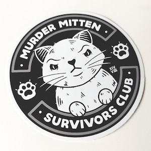 May include: Black and white sticker featuring a cartoon cat with a grumpy expression. The sticker reads "Murder Mitten Survivors Club" with paw prints on either side.