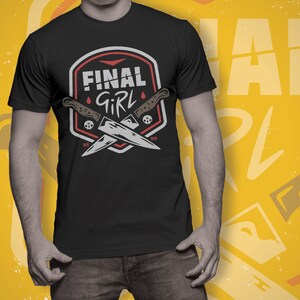 K&ouml;nnte beinhalten: Schwarzes T-Shirt mit einer roten und wei&szlig;en Grafik von zwei gekreuzten Messern und dem Text "Final Girl".