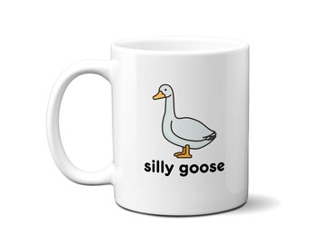 Könnte beinhalten: Weiße Keramiktasse mit einer schwarzen Umrisszeichnung einer Gans und dem Text "silly goose" in Schwarz.