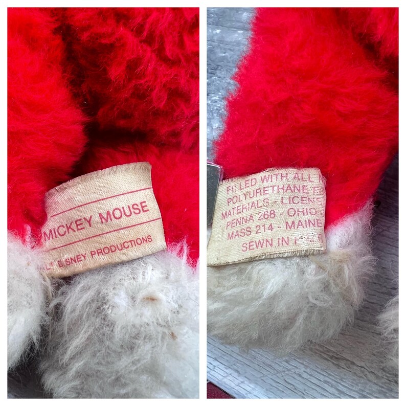May include: Close-up of a vintage Mickey Mouse plush toy. The toy has red fur with white accents and a tag that reads "MICKEY MOUSE" and "WALT DISNEY PRODUCTIONS". Another tag indicates the toy is filled with polyurethane materials.