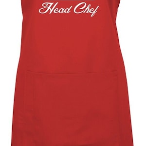 May include: Red apron with a white chef hat and the text "EMMA Head Chef" printed on the front.