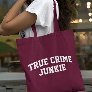 May include: A maroon tote bag with white text that reads "TRUE CRIME JUNKIE".