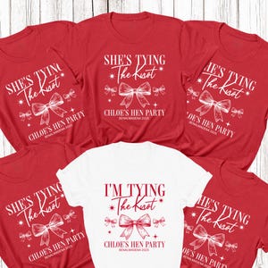 May include: Red and white t-shirts with the text "She's Tying The Knot" and "I'm Tying The Knot" in white script. Each shirt features a bow graphic and the text "Chloe's Hen Party Benalmadena 2025".