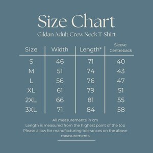 May include: A size chart for a Gildan Adult Crew Neck T-Shirt on a blue background. The table lists sizes S through 3XL with corresponding width, length, and sleeve centreback measurements in cm. Text includes Size Chart, Gildan Adult Crew Neck T-Shirt, and notes on manufacturing tolerances.