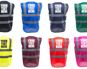 May include: Eight safety vests in different colors, including black, blue, navy, green, yellow, maroon, red, and pink. Each vest has reflective strips and a white rectangular area on the back that says "YOUR TEXT HERE".