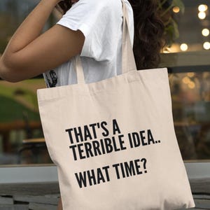 ¡Qué idea tan terrible! ¿A qué hora? Bolsa de algodón ligera para compras, regalo, eslogan, bolsa divertida para el humor.