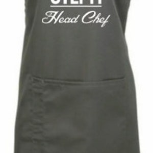 May include: A gray apron with a white chef hat graphic and the text "STEPH Head Chef".