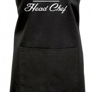 May include: Black apron with a white chef hat graphic and the text "CAZ Head Chef".