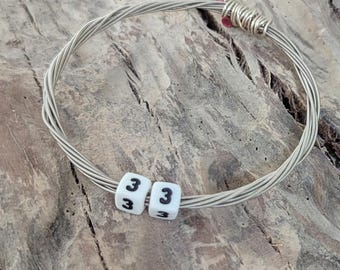 Billy Strings inspired bracelet.  Recycled guitar string bangle with the numbers 33.