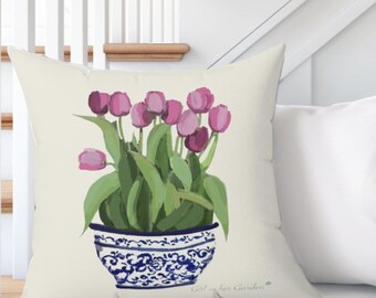 May include: A white throw pillow with a blue and white floral design featuring pink tulips in a blue and white porcelain vase. The pillow has the text "Emily for Handmade" printed on the bottom.