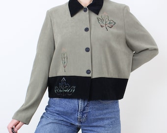 May include: A green suede jacket with a black velvet collar and trim. The jacket has a button-up front and features embroidered leaf designs in shades of green, brown, and red.
