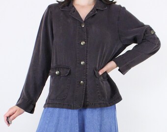 May include: A dark brown, long-sleeved button-up shirt with a collared neckline and two front pockets. The shirt has a relaxed fit and is made of a soft, comfortable fabric.