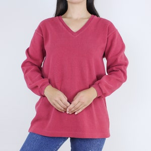 May include: A long-sleeved, v-neck, crimson sweatshirt.
