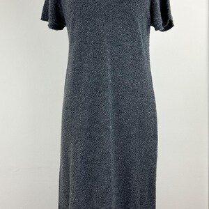 May include: A gray short-sleeved knit dress on a mannequin.