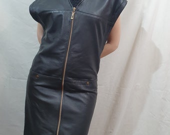 Stylish dress made of genuine leather in black. Leather dress made of black leather with a long metal zipper in the front