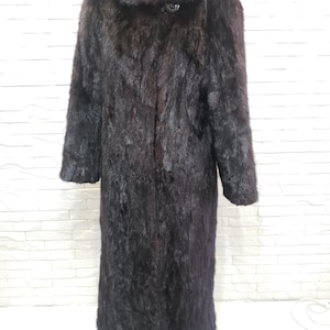 Stylish women&#39;s mink fur coat. Warm brown women&#39;s fur coat made of genuine mink fur.