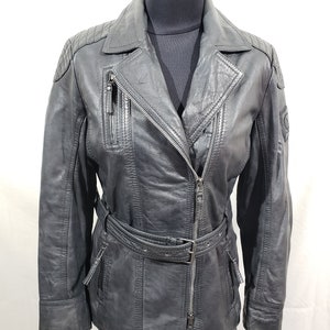 Cute ladies leather biker jacket with metal zipper. Women&#39;s leather black jacket