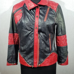 Stylish women&#39;s black leather jacket with red inserts. Women&#39;s sports jacket with a zipper and buttons.