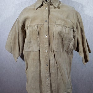 Stylish women&#39;s shirt made of genuine suede. Beige women&#39;s shirt made of genuine leather.