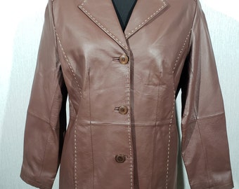 Wonderful brown women's genuine leather jacket. Classic women's long leather jacket with buttons.