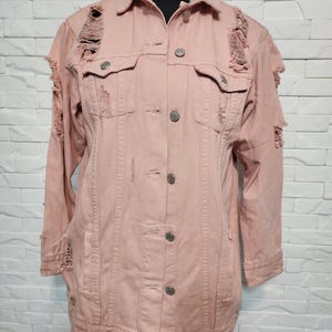 Women&#39;s denim jacket. Pink women&#39;s cotton jacket with a decorative design.