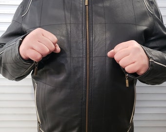 Delightful man's leather jacket. Man's leather jacket with white leather accents. Jacket for bikers and rockers. Jacket with a zipper.