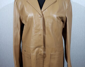 Wonderful brown women's genuine leather jacket. Classic women's elongated leather jacket with metal snaps.