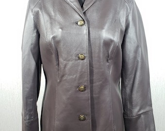 May include: A brown leather jacket with a classic design. The jacket features a notched collar, long sleeves, and three button closure. The jacket is displayed on a black mannequin.