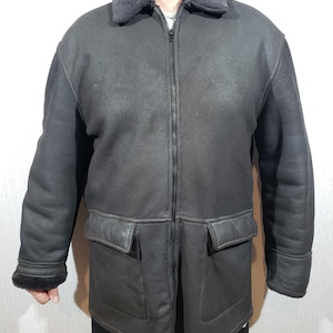 Stylish men&#39;s black sheepskin coat. Reliable men&#39;s sheepskin coat with zipper.